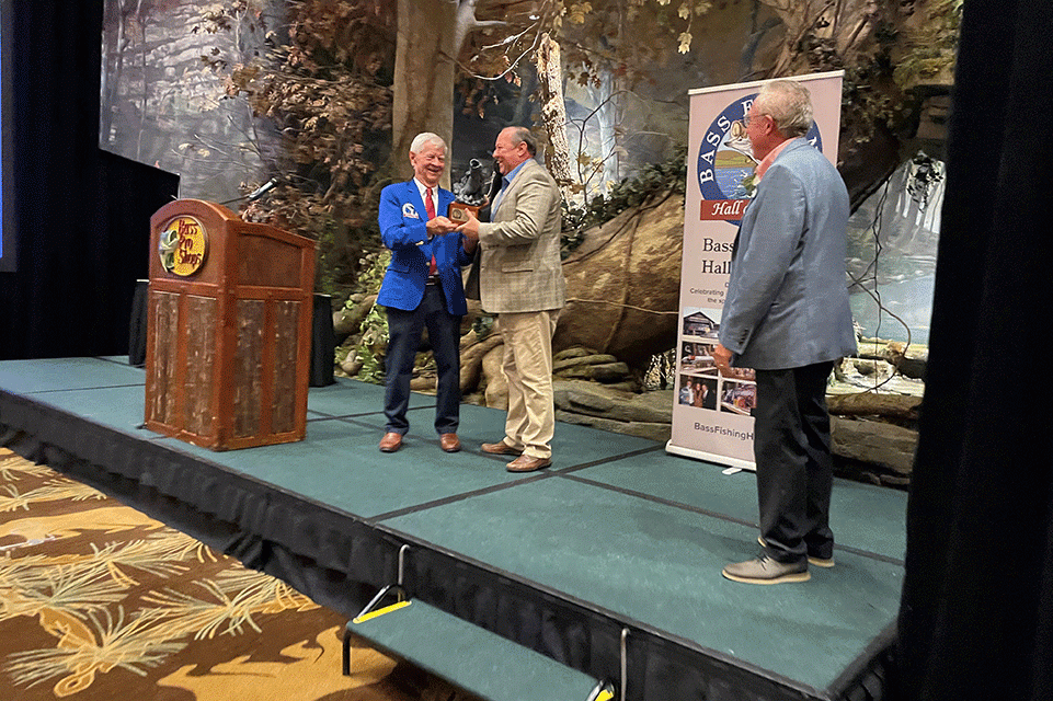 Bruce Akin, on his last night serving as B.A.S.S. CEO, received the BFHOF Meritorious Service Award from longtime Bassmaster magazine editor Dave Precht, who previously served on the hall board, and hall president John Mazurkiewicz.