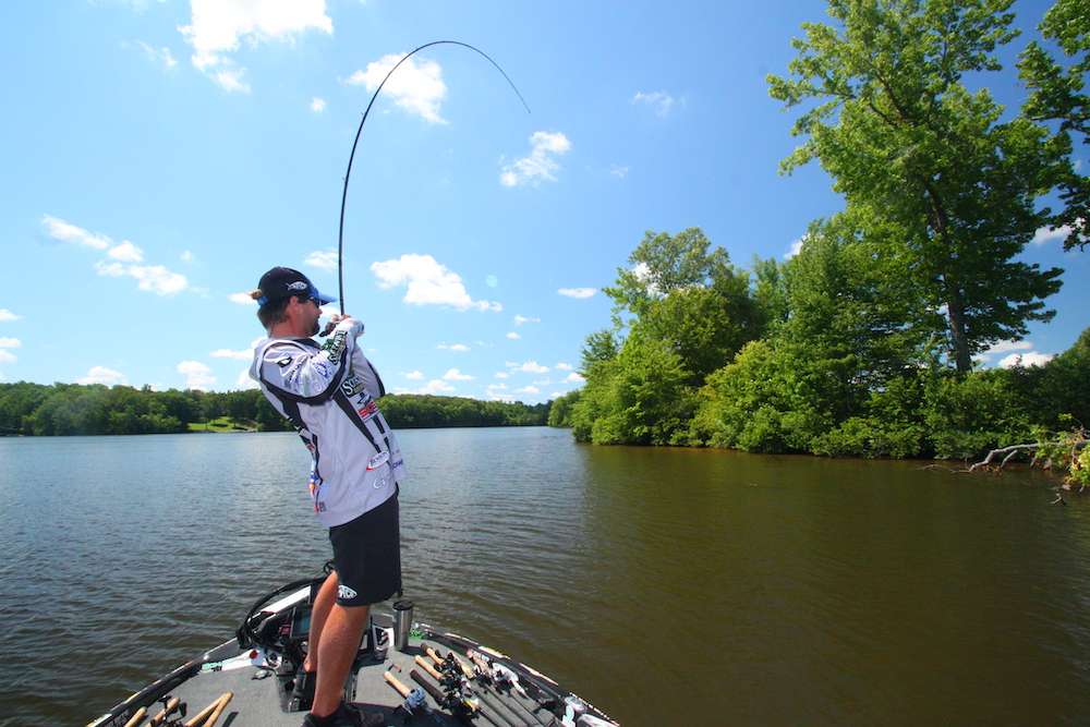 <b>10:53 a.m.</b> Cook flips the finesse jig to the end of a laydown on the channel bank. A bass taps it as itâs sinking, he hammers the fish and it instantly wraps his line around a branch. Cook maneuvers his boat closer, drops to his stomach and plunges his arm in the water in an attempt to unwrap the line from the snag. <br>
<b>10:59 a.m.</b> âGotcha!â Cook hollers as he finally wrestles aboard his prize, a spectacular 6-pound, 8-ounce largemouth! âShe sucked in the jig as it was sinking, then immediately wrapped my line.â <br>
<b>11:04 a.m.</b> Cook continues down the channel bank, alternating between the squarebill and jig. <br>
<b>11:16 a.m.</b> Failing to score another strike on the channel bank, Cook runs to an offshore rockpile and idles around the structure. âThat 6-8 was the kind of bite that can distract you from what you really need to be doing right now, which is fishing offshore. I fished that whole stretch of channel bank and didnât get another tap. Interestingly, the laydown where that big fish was holding was the only wood in the water along that entire bank with green leaves on its branches.â <br>
<b>11:29 a.m.</b> Cook has cranked the RkCrawler 360 degrees around the rockpile without a strike. He moves straight across the lake to a clay point with scattered brushpiles and tries the Fat Papa.
<br><br>
<b>2 HOURS LEFT</B><BR>
<b>11:35 a.m.</b> Cook hangs the Fat Papa in submerged brush and retrieves it. <br>
<b>11:39 a.m.</b> He drags the 10-inch worm around the point. <br>
<b>11:46 a.m.</b> Cook makes a blistering run downlake to the rock point he fished earlier. He tries the worm and Fat Papa. <br>
<b>11:52 a.m.</b> He moves closer to shore to crank the RkCrawler around an old boat ramp. âBass love to hang around a gnarly old ramp like this â the more busted-up, the better. At least thatâs what I read in <em>Bassmaster</em>.â <br>
<b>12:07 p.m.</b> Cook moves farther down the bank and cranks the squarebill. <br>
<b>12:10 p.m.</b> Cook cranks up a submerged limb. âTree-pounder!â <br>
<b>12:22 p.m.</b> Cook roars back uplake to the mud point he fished earlier. He drops his trolling motor 100 yards from the structure and begins fishing his way toward it with the Fat Papa. <br>
<b>12:24 p.m.</b> Cook casts the 10-inch worm to a submerged brushpile. A fish bumps the crawler; he swings back his rod, and the bass spits it out. âThatâs another good fish Iâve lost on the worm! Theyâre just not hanging onto it.â <br>
<b>12:28 p.m.</b> Another tap, another swing, another miss with the worm. âUnbelievable!â
<br><br>
<b>1 HOUR LEFT</b><br>
<b>12:35 p.m.</b> Cook catches his 10th keeper, 2 pounds, 14 ounces; off the mud point on the Fat Papa. <br>
<b>12:49 p.m.</b> Cook bags keeper No. 11, 2 pounds, 15 ounces, on the RkCrawler.
