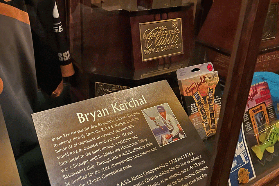 A display showing artifacts from Bryan Kerchalâs career sit in a case inside the Bass Fishing Hall of Fame, including his original Classic trophy from 1994.