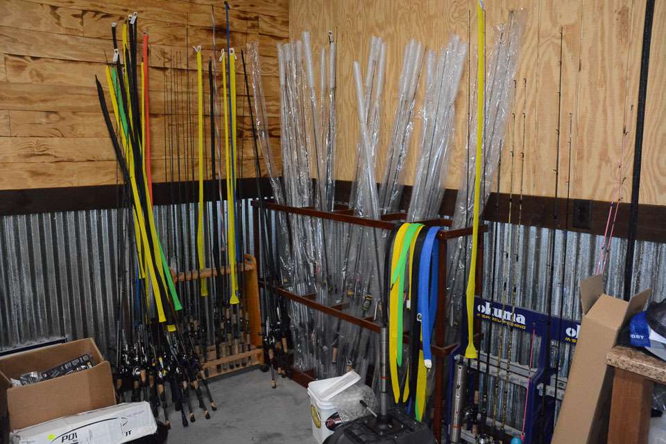 In the back corner of the man cave is rod storage. At left is a pile of Lewâs combos recently removed from his boat following the final 2021 Elite Series event on the St. Lawrence River. To the right are spare rods in the rack made by Arey. 