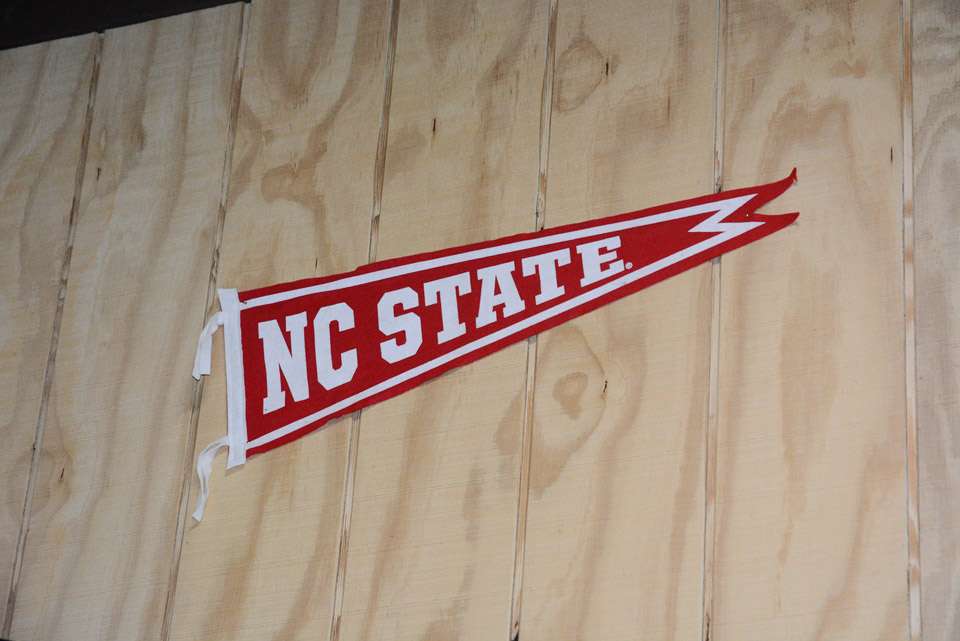Arey has this banner on the wall for no other reason than to proclaim he is an alumnus of North Carolina State University. 