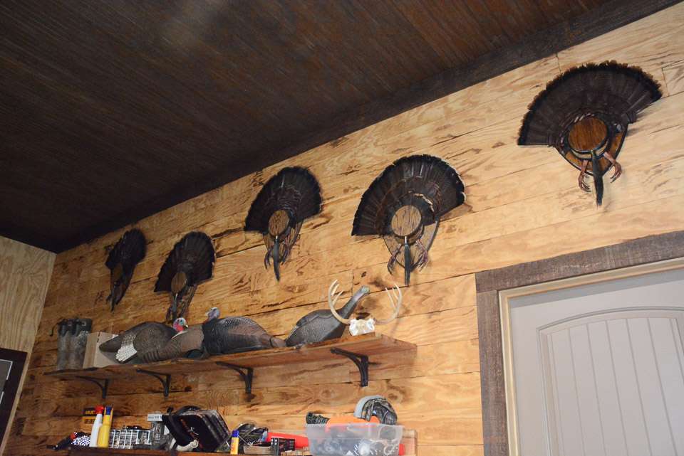 Turkey fan mounts are displayed above the gear to proclaim Areyâs love for hunting the elusive game birds. 