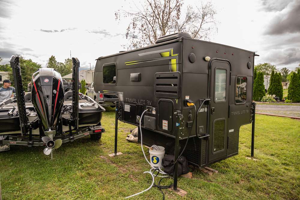 Beside the boat is the Travel Lite RV camper. It fits nicely in the back of Downeyâs tow rig and is his home away from home on the road.