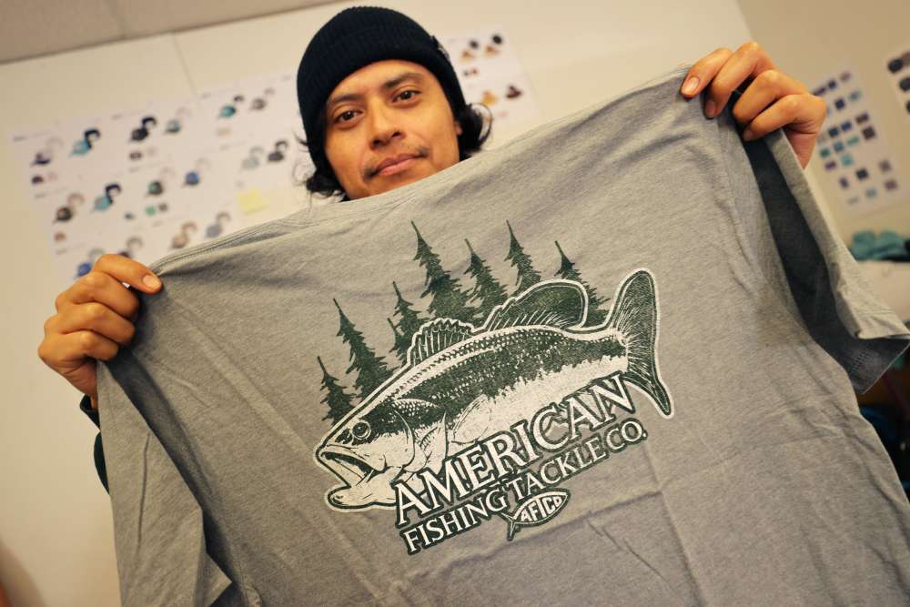 Jose Garcia Diaz shows off one of his most recent designs for the freshwater market as he designs all of AFTCOâs T-shirts and hats.