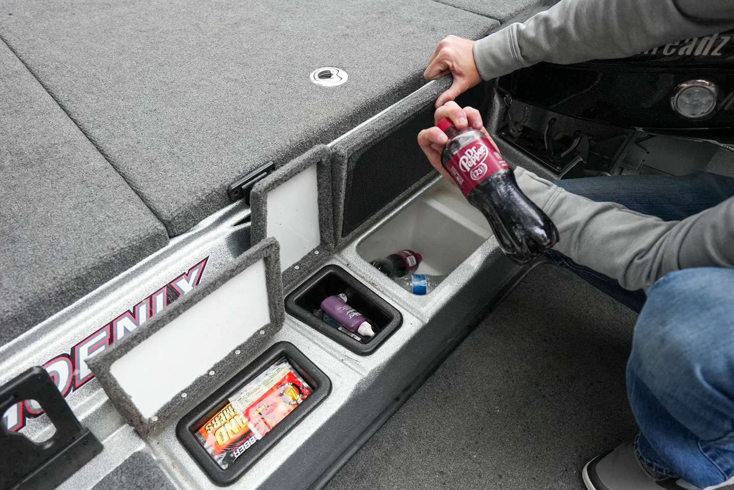 The step to the front deck actually serves as three separate compartments. Two of the compartments are home to smaller tools and miscellaneous items while the third compartment is the cooler.  