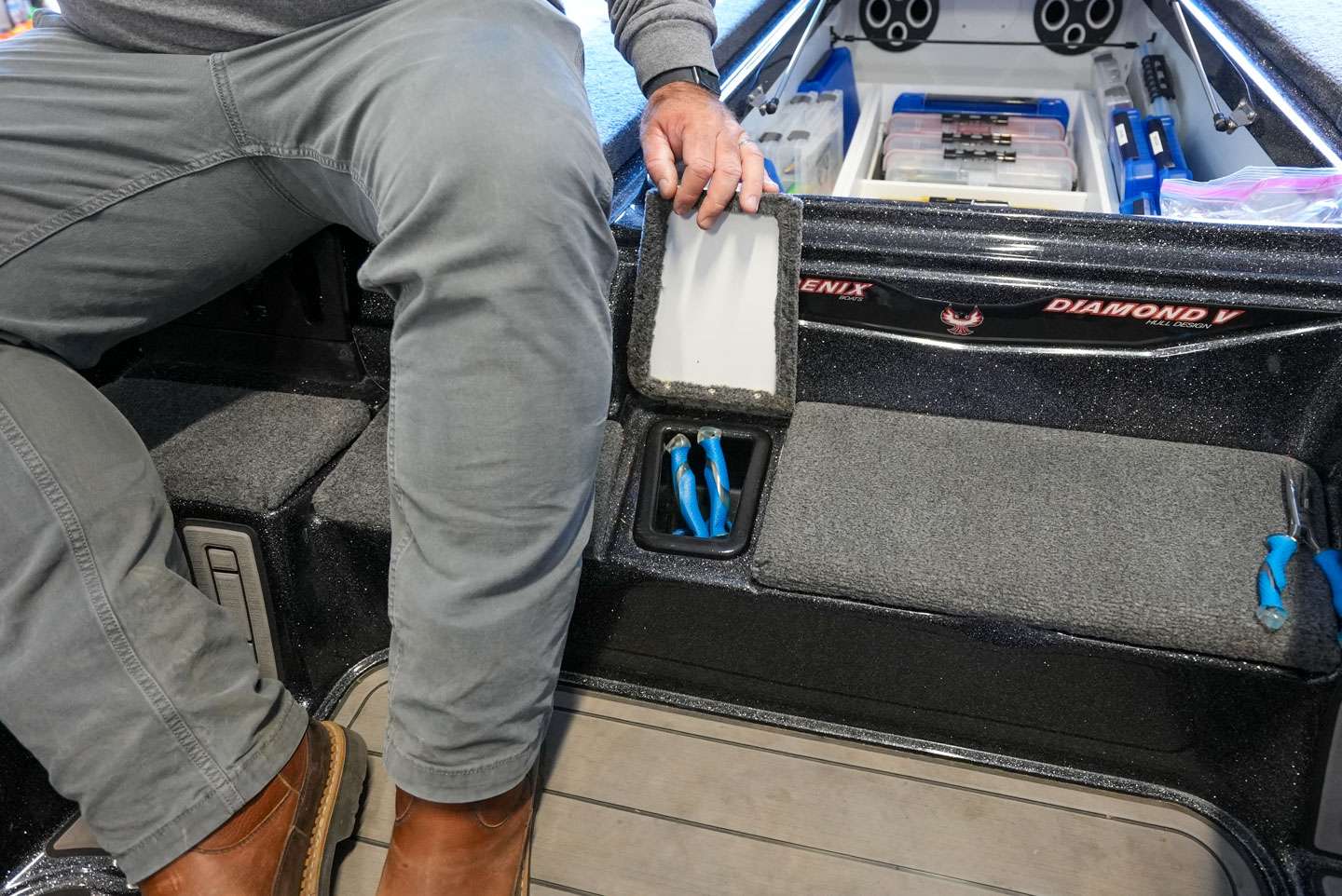 Phoenix boats have a unique step that serves as a cooler and a space for additional storage. Davis stores his tools in the compartment next to the cooler. 