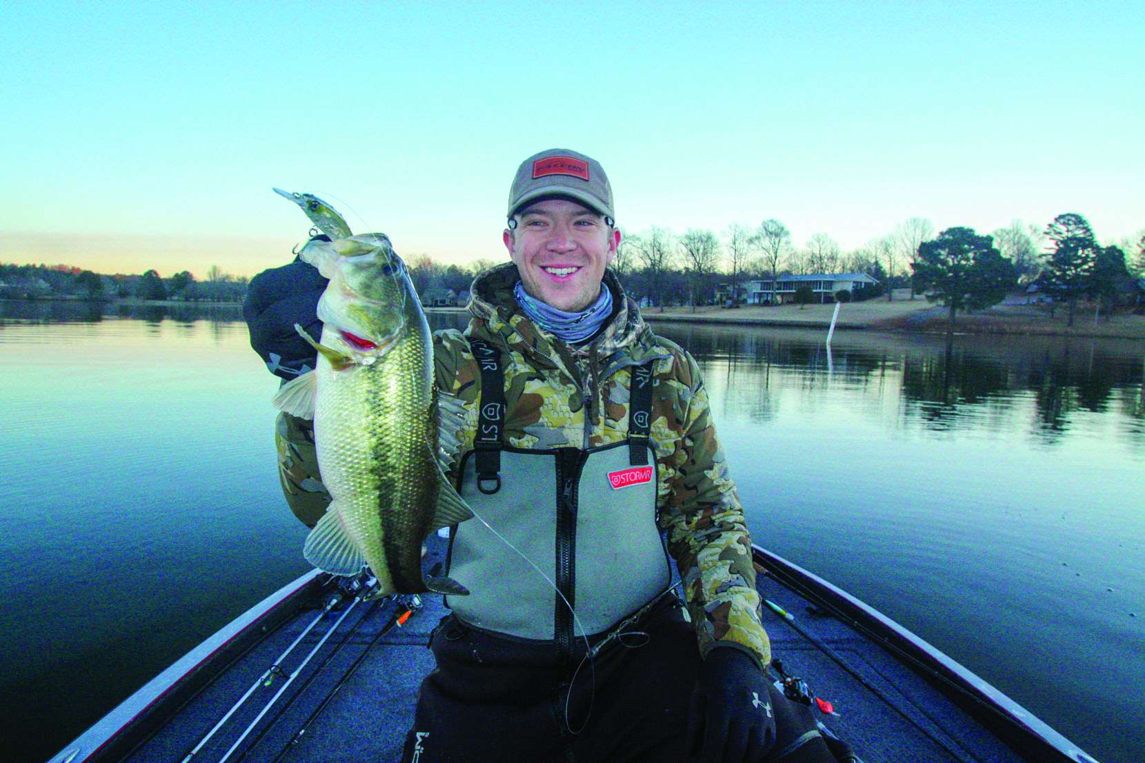 <b>7:17 a.m.</b> He switches to the jerkbait around the rockpile and bags his first keeper bass of the day, a 1-pound, 8-ounce largemouth; the tail of a shad is protruding from its mouth. “Greedy little guy! I’m seeing several fish this size down there on the Garmin. They’re 8 feet deep.” <br />
<b>7:20 a.m.</b> Back to the A-rig. He gets a tap but no hookup. “I’ve got a couple of dummy shad on there [with no hooks], and invariably those are the ones that get bit.” <br />
<b>7:26 a.m.</b> Walters casts a single Storm Largo swimbait on a 3/8-ounce head to the rockpile. <br />
<b>7:29 a.m.</b> He tries the DT06 on the rockpile. <br />
<b>7:31 a.m.</b> Walters catches keeper No. 2, 1 pound, off the rockpile on the Whipper Snapper.<br />
” class=”wp-image-568516″ width=”1660″ height=”1107″/><figcaption><b>7:17 a.m.</b> He switches to the jerkbait around the rockpile and bags his first keeper bass of the day, a 1-pound, 8-ounce largemouth; the tail of a shad is protruding from its mouth. “Greedy little guy! I’m seeing several fish this size down there on the Garmin. They’re 8 feet deep.” <br />
<b>7:20 a.m.</b> Back to the A-rig. He gets a tap but no hookup. “I’ve got a couple of dummy shad on there [with no hooks], and invariably those are the ones that get bit.” <br />
<b>7:26 a.m.</b> Walters casts a single Storm Largo swimbait on a 3/8-ounce head to the rockpile. <br />
<b>7:29 a.m.</b> He tries the DT06 on the rockpile. <br />
<b>7:31 a.m.</b> Walters catches keeper No. 2, 1 pound, off the rockpile on the Whipper Snapper.<br />
</figcaption></figure>
<figure class=