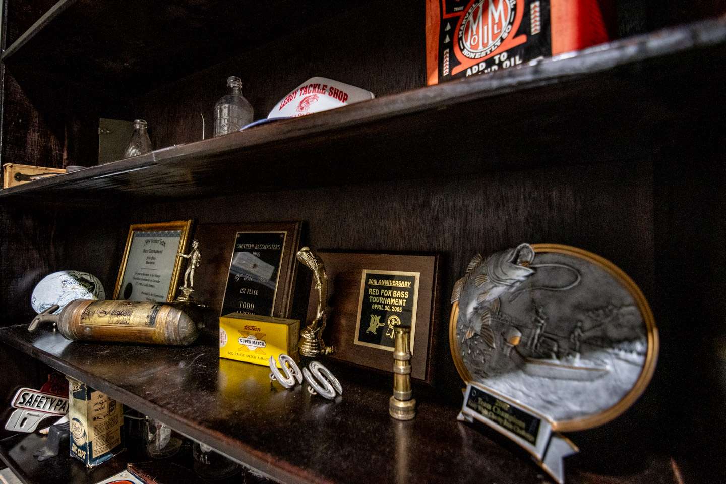 The shelf wouldn’t be complete without a few bass fishing trophies from his long past as a tournament angler. 