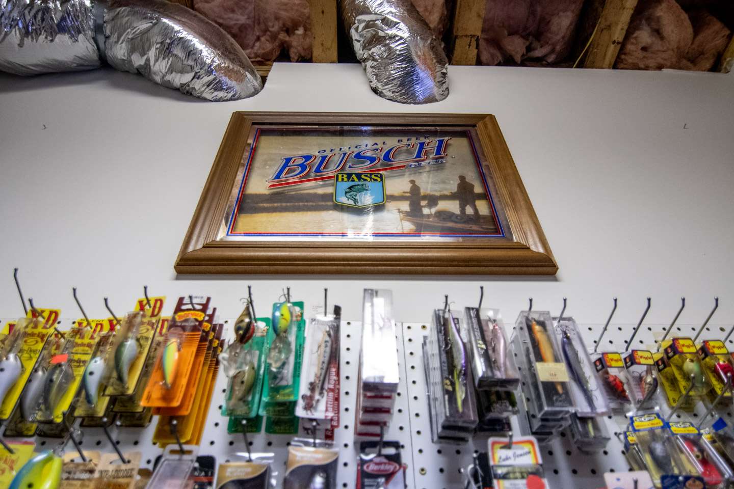 Acquired at one of his first Bassmaster Classics is a B.A.S.S. logo-adorned Busch frame which decorates the wall above the pegboard. 
