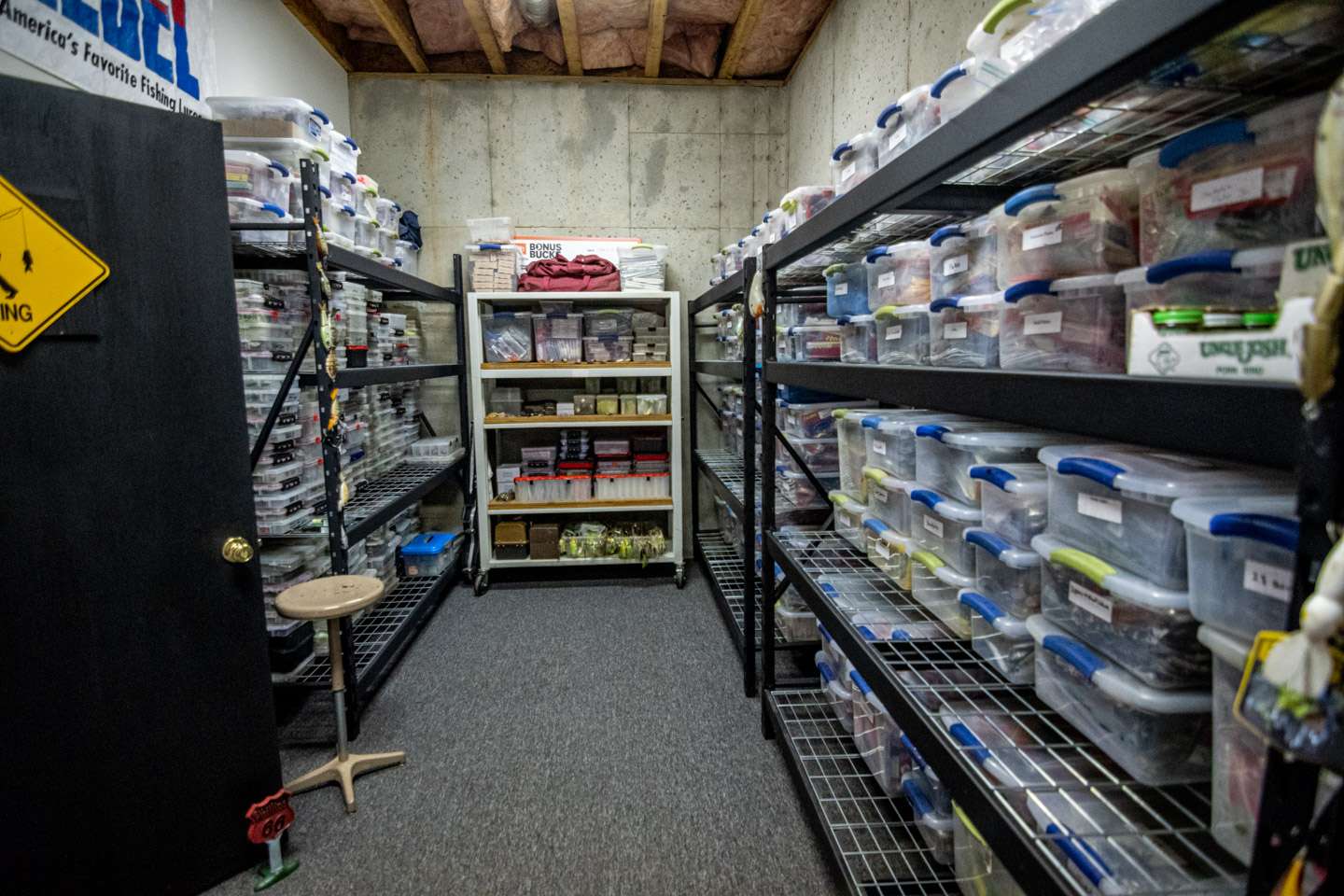 The other half of the tournament tackle room has metal shelving for his Tupperware boxes full of baits. 