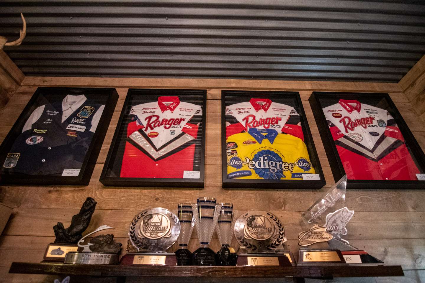Along the top of the wall are Auten’s framed jerseys from various fishing championships, beginning with his 1999 Classic jersey.   