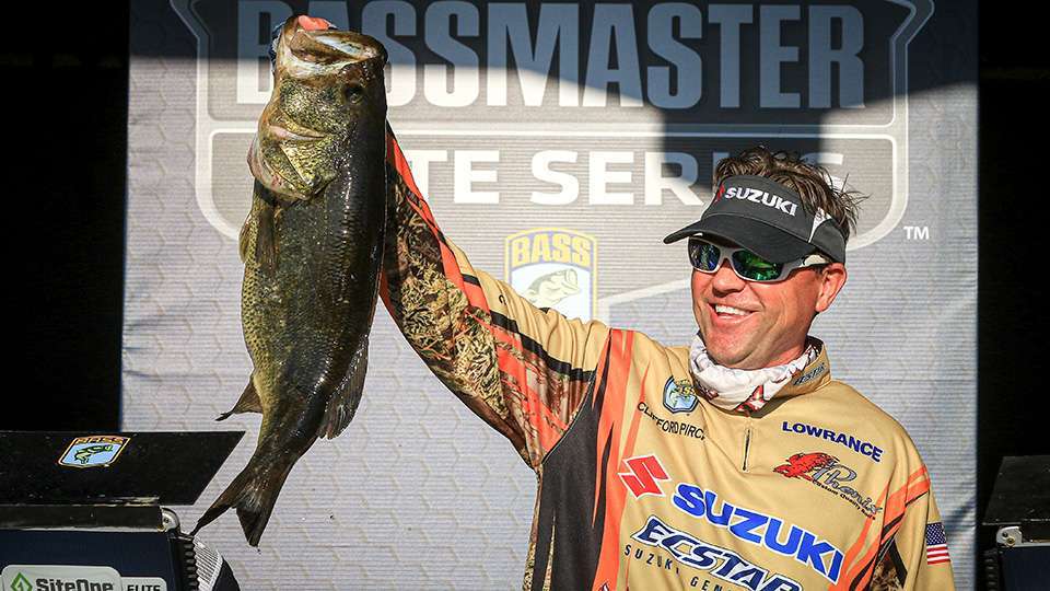 Talk was that Clifford Pirch’s lunker would take the tournament lead for big bass. The Bassmaster LIVE crew discussed that Pirch’s bass, which was relayed by Marshal David Frost in a video, looked bigger than Cox’s fish. The relative size of the anglers or camera perspective might have had something to do with that. Perhaps the morning catch sitting in the livewell and holding Pirch as the last to weigh played a factor too. Pirch seemed a touch surprised when it went 9-13 on the scales, drawing a disappointed reaction from the crowd hoping to see another double-digit fish. Pirch then said he weighed it earlier and it went 10-4. 
