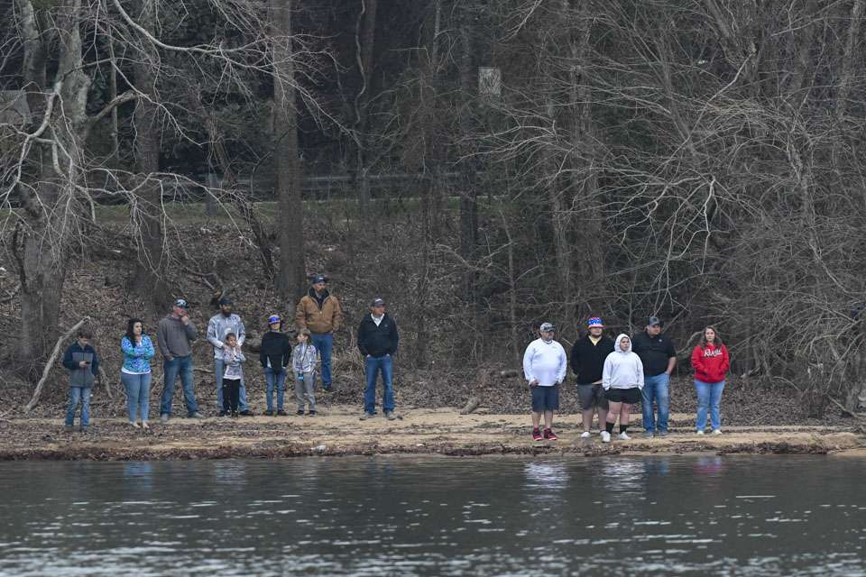 Spectators gathered on the banks of the cove just off the road to watch.