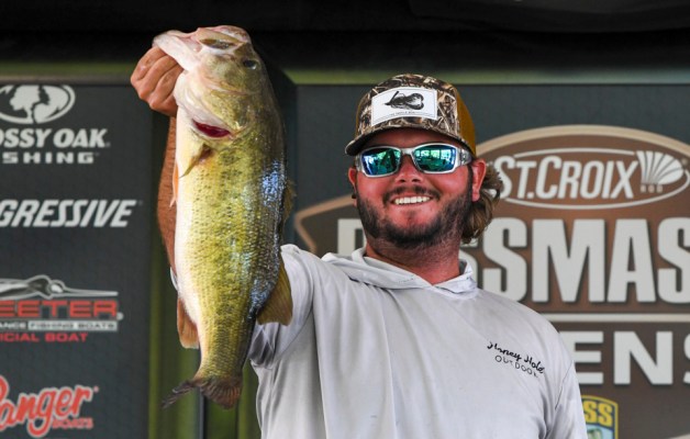 David Gaston holds up a largemouth bass on the Bassmaster Opens stage