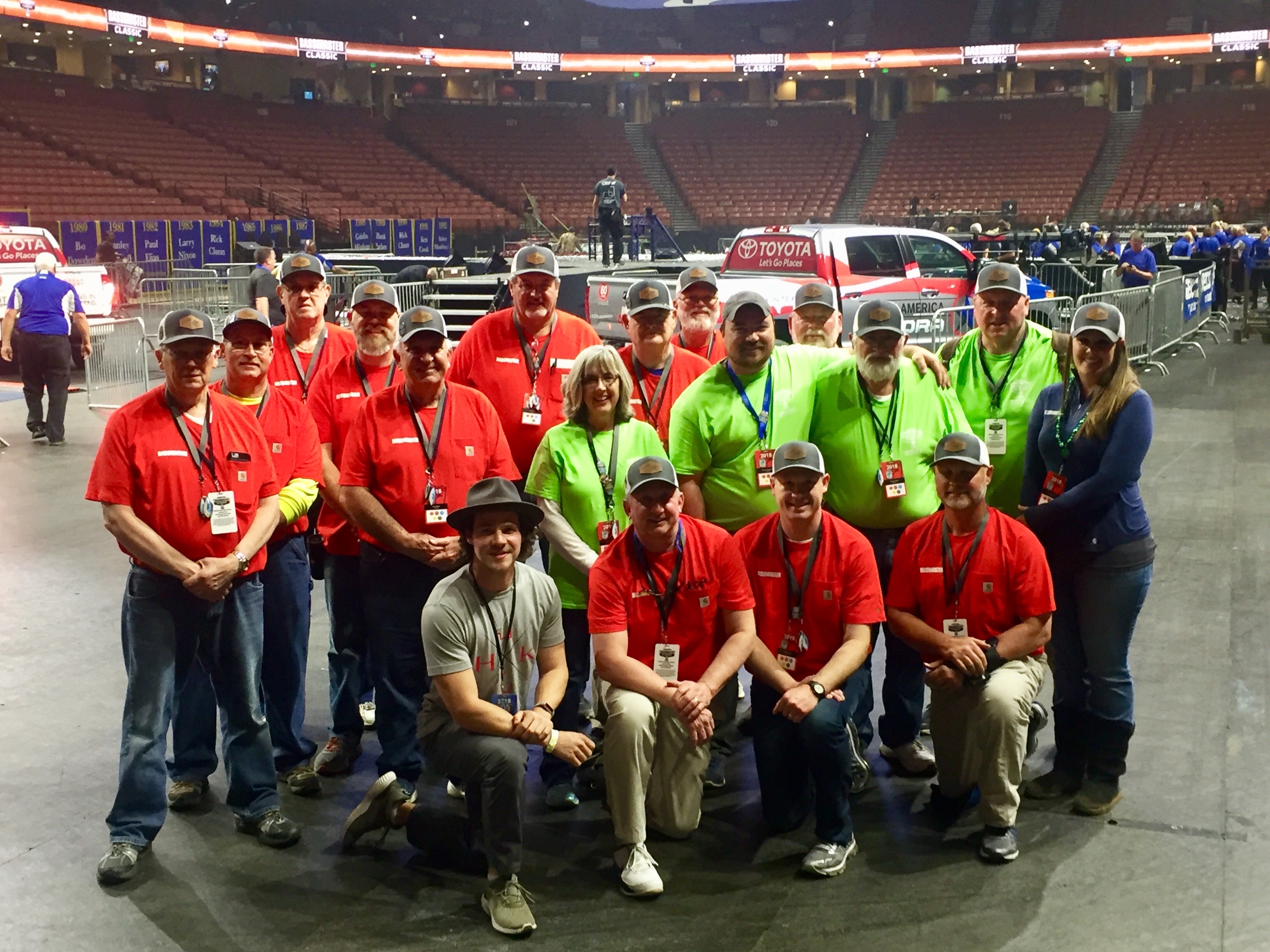 Volunteers pose on the arena floor before the Classic
